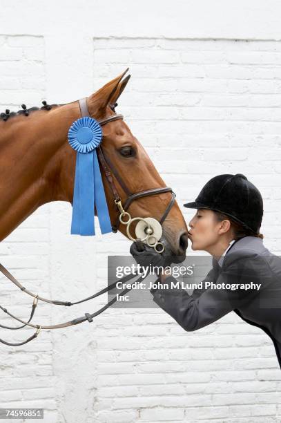 hispanic female equestrian kissing horse - riding habit stock pictures, royalty-free photos & images