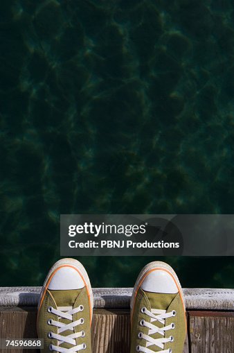 Sneakers on dock over water Sneakers on dock over water