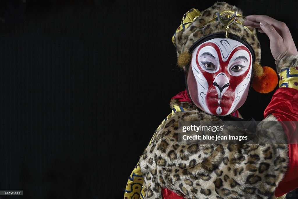 Portrait of a young actor dressed as Monkey King posing on stage.