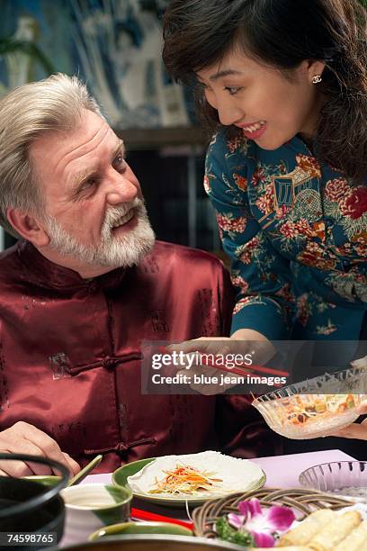waitress serves man at a chinese restaurant. - waitress booth stock pictures, royalty-free photos & images