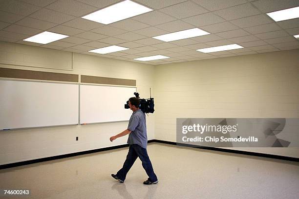 Television photographer moves thorugh one of classrooms on the second floor of Norris Hall ahead of the phased re-use of building June 14, 2007 in...