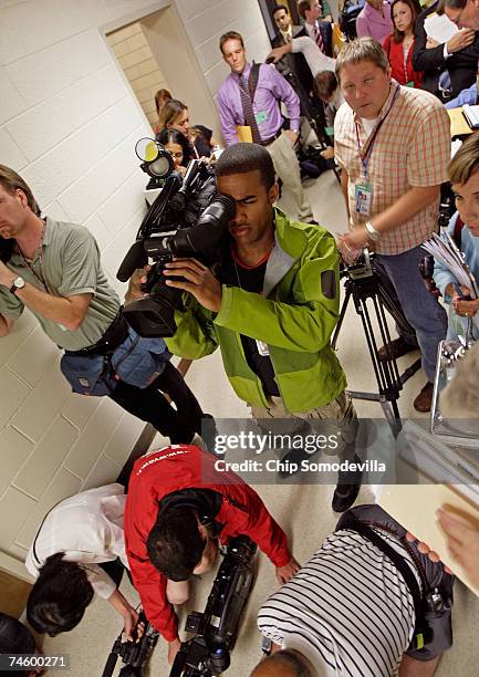 Television photographers film down the long hallway on the second floor of Norris Hall ahead of the phased re-use of building June 14, 2007 in...