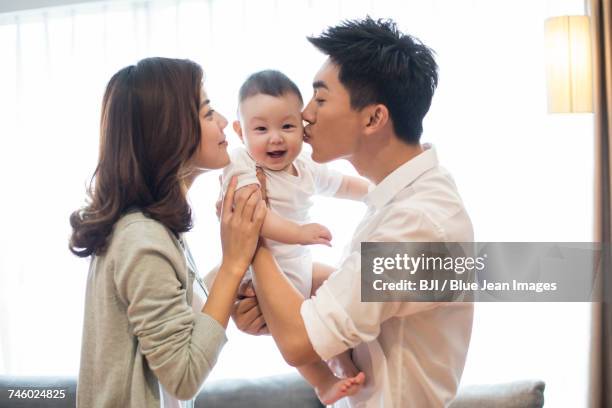 happy young family - baby father hug side stock pictures, royalty-free photos & images