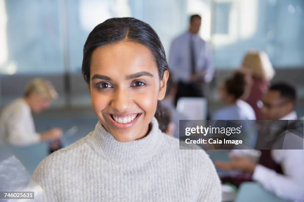 portrait smiling businesswoman in conference room meeting - high collar stock-fotos und bilder
