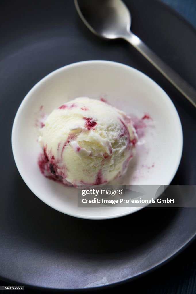 A scoop of blackberry and blueberry ice cream in a bowl