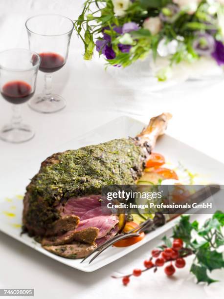 leg of lamb with a herb crust - leg of lamb stock pictures, royalty-free photos & images