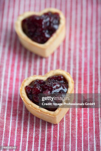 heart-shaped biscuits filled with cranberry jam - cranberry heart stock pictures, royalty-free photos & images