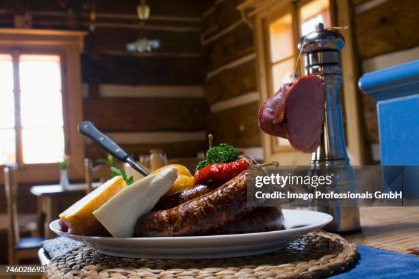 interior of the restaurant, different cheeses, sausages and paprika with onions on a table - jause bildbanksfoton och bilder