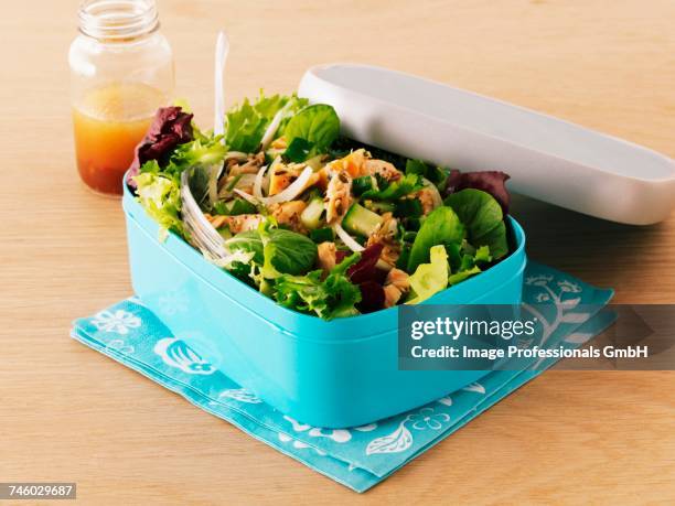 mixed leaf salad with smoked salmon in a lunch box with a jar of dressing - curly endive stock pictures, royalty-free photos & images