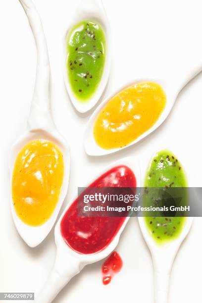 assorted fruit pures on spoons - pure white background bildbanksfoton och bilder