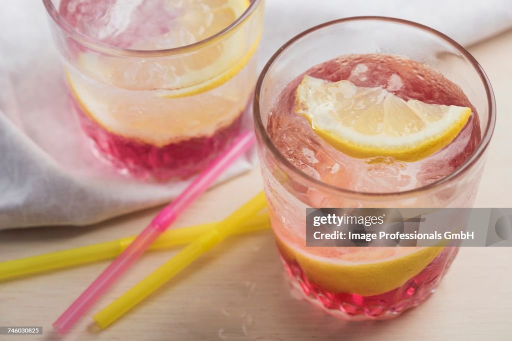 Pink lemondade with ice cubes and Meyer lemons