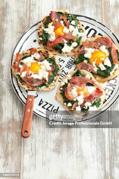 mini tortilla pizzas with spinach, ham, egg and feta cheese - tortilla stock pictures, royalty-free photos & images