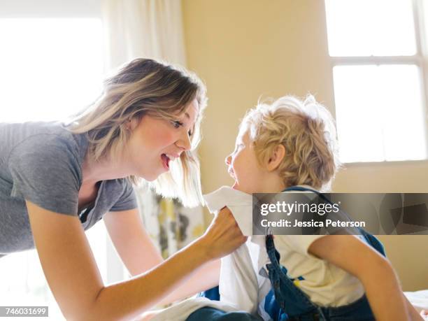 mother cleaning sons face (4-5) with towel - gnugga bildbanksfoton och bilder