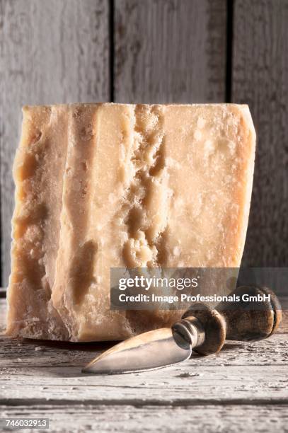 a large piece of grana padano cheese - grana padano bildbanksfoton och bilder