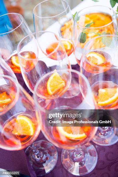 aperol in wine glasses - vitreous stock pictures, royalty-free photos & images