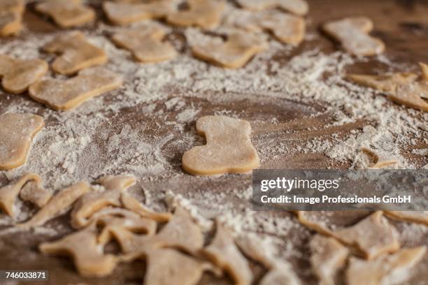 cut-out biscuits and leftover pastry on a floured work surface - floured surface stock pictures, royalty-free photos & images