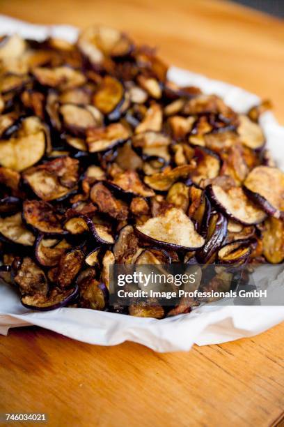 a pile of aubergine chips - vegetable chips stock pictures, royalty-free photos & images