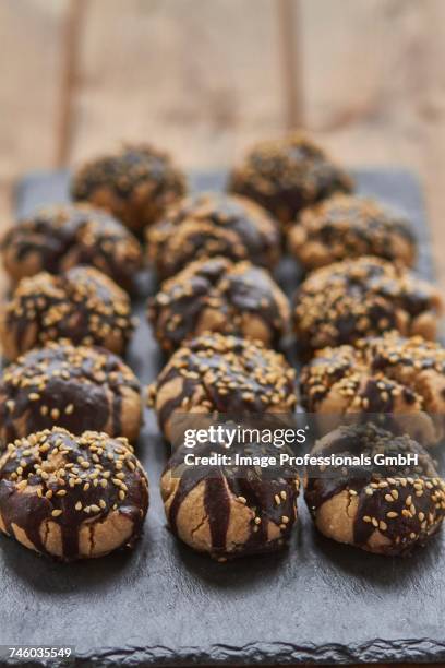 polvorones (spanish biscuits) with chocolate glaze and sesame seeds - polvorón stock pictures, royalty-free photos & images