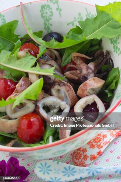 squid salad with dandelions, olives and cherry tomatoes - aclamar stock pictures, royalty-free photos & images