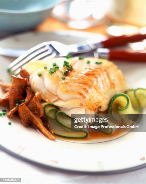 fillet of cod with girolle mushrooms and courgettes - cantharellus tubaeformis stock pictures, royalty-free photos & images