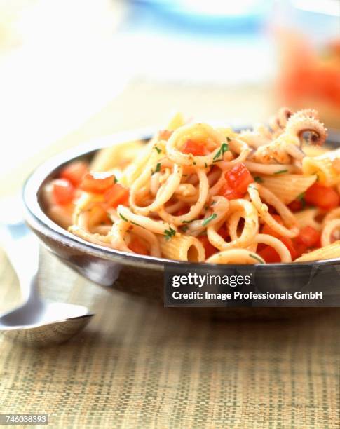 penne pasta with squid and tomatoes - aclamar stock pictures, royalty-free photos & images