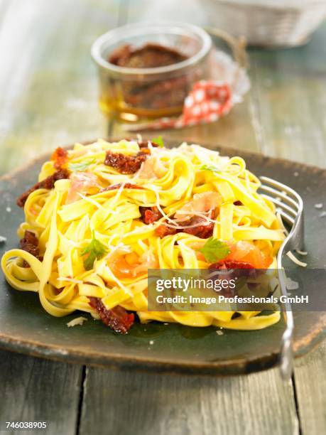tagliatelles with sun-dried tomatoes - tomatoes chutney stock pictures, royalty-free photos & images