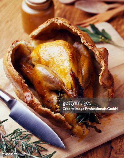 guinea fowl baked in salt and herb case - faraona comune foto e immagini stock