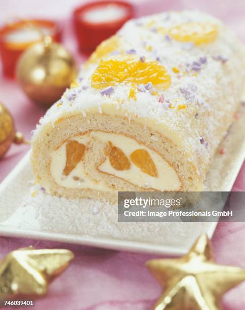 white chocolate,mandarin and coconut christmas log cake - yule log stock pictures, royalty-free photos & images