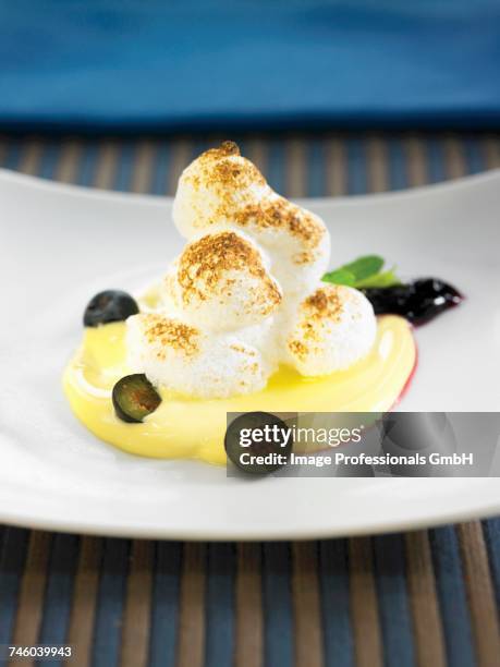 whipped egg whites with lemon cream and grapes - floating island stock pictures, royalty-free photos & images