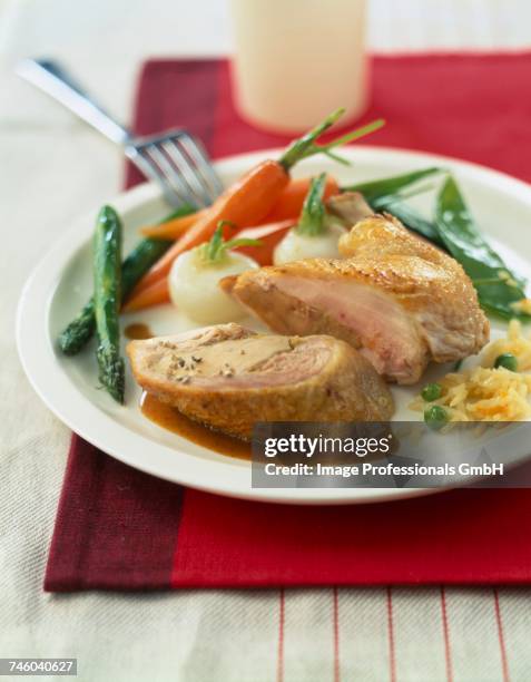 foie gras-stuffed poultry with baby vegetables - guineafowl stock-fotos und bilder