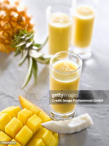 mango-pineapple-coconut smoothies - mango smoothie stock pictures, royalty-free photos & images