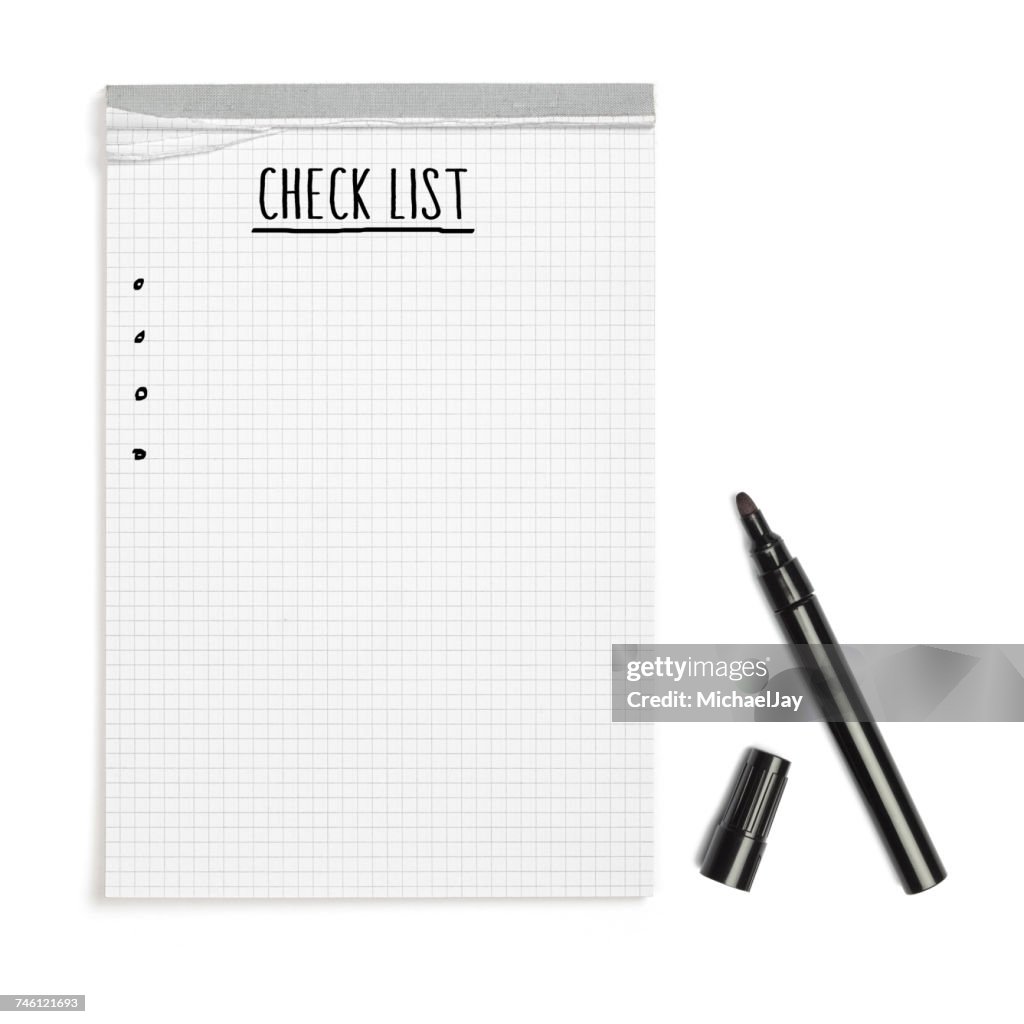 High Angle View Of Checklist Text On Note Pad With Felt Tip Pen Over White Background