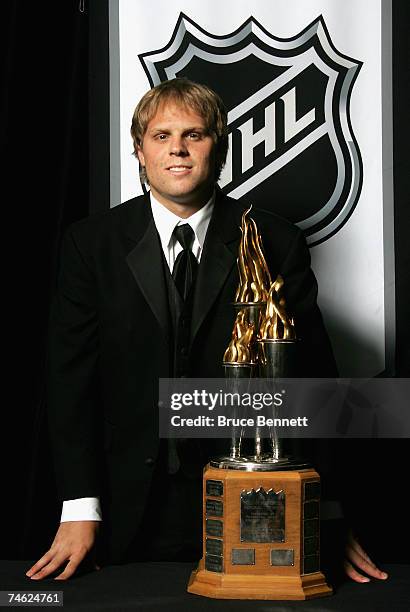 Phil Kessel of the Boston Bruins poses for a portrait backstage with Bill Masterton Memorial Trophy for Qualities of Perseverance and Sportsmanship...