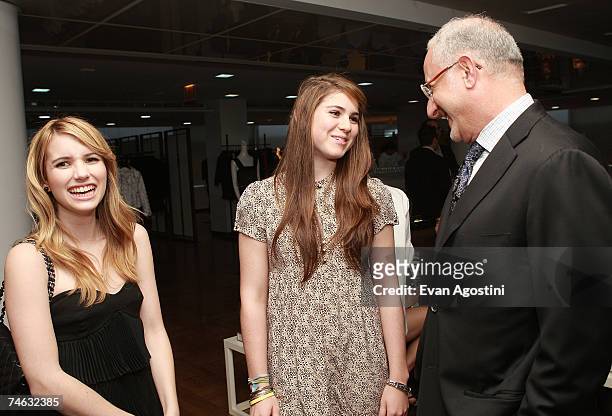 Barneys New York chairman Howard Socol chats with actress Emma Roberts and Emily McEnroe at a cocktail party to celebrate Vanity Fair's July Africa...