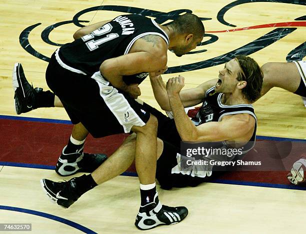 Tim Duncan and Fabricio Oberta of the San Antonio Spurs shout at each other after a three-point play against the Cleveland Cavaliers in Game Four of...