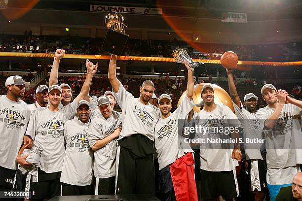 The San Antonio Spurs celebrate with the Larry O'Brien NBA Championship Trophy after their 83-82 win against the Cleveland Cavaliers in Game Four of...