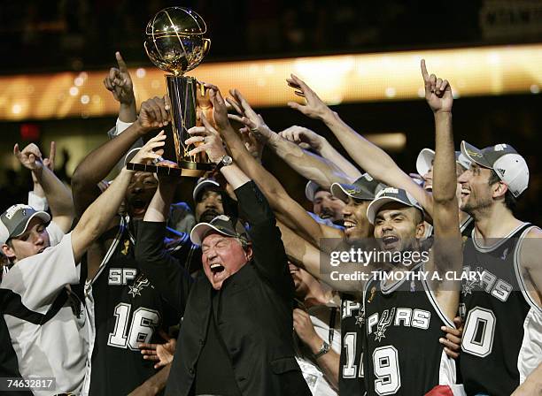 Cleveland, UNITED STATES: MVP Tony Parker of the San Antonio Spurs celebrates with Spurs' CEO Peter Holt and teammates after leading the San Antonio...