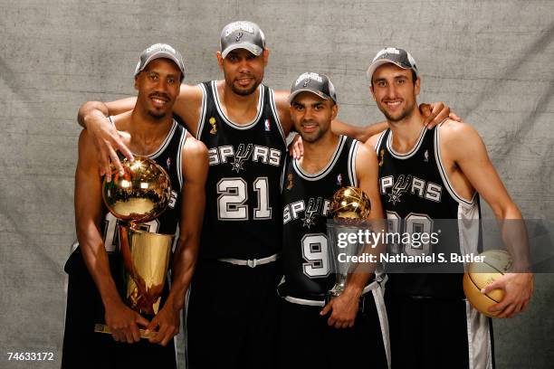 Bruce Bowen, Tim Duncan, Finals MVP Tony Parker and Manu Ginobili of the San Antonio Spurs pose for a photo with the Larry O'Brien Championship...