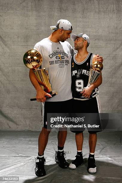 Tim Duncan and head Finals MVP Tony Parker of the San Antonio Spurs pose for a portrait with the Larry O'Brien Championship trophy after they won the...