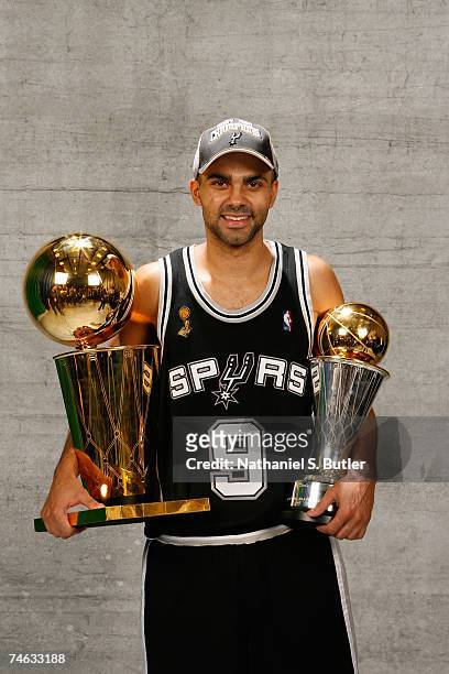 Finals MVP Tony Parker of the San Antonio Spurs pose for a portrait with the Larry O'Brien Championship trophy after they won the 2007 NBA...