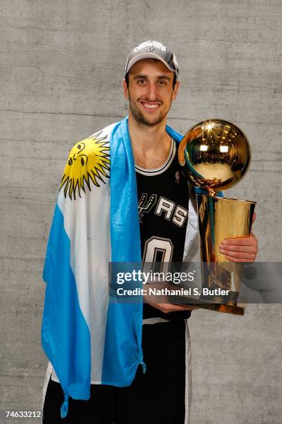 Manu Ginobili of the San Antonio Spurs poses for a portrait with the Larry O'Brien Championship trophy after they won the 2007 NBA Championship with...