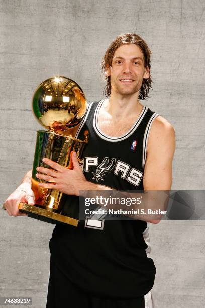 Fabricio Oberto of the San Antonio Spurs poses for a portrait with the Larry O'Brien Championship trophy after they won the 2007 NBA Championship...