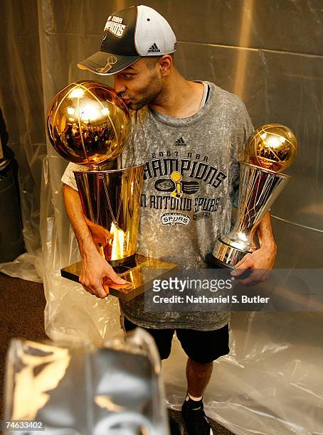 Finals MVP Tony Parker the San Antonio Spurs celebrates in the locker with the Larry O'Brien Championship trophy and his MVP trophy after their 83-82...
