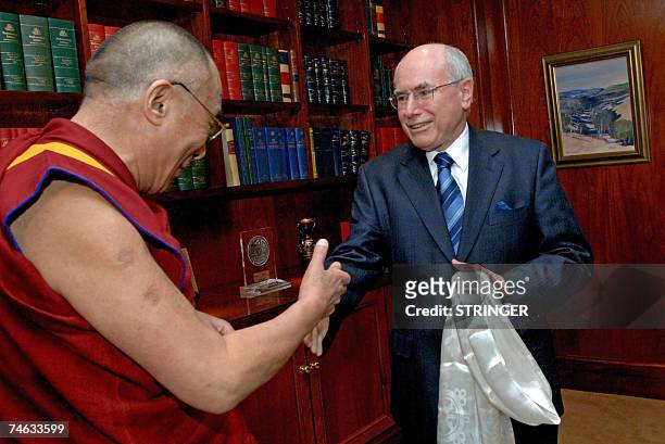 Australian Prime Minister John Howard shakes hands with the Dalai Lama during their meeting in Sydney, 15 June 2007. Howard met the Dalai Lama, who...