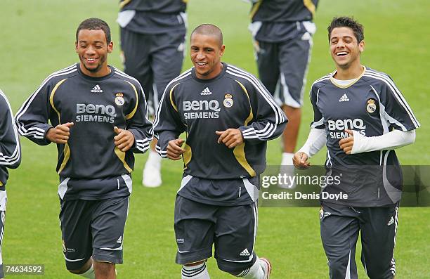 Brazilians Marcelo Roberto Carlos and Cicinho of Real Madrid warm up during the team training session at the Valdebebas grounds on June 15, 2007 in...