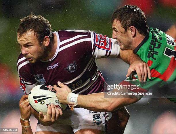 Glenn Stewart of the Sea Eagles is tackled during the round 14 NRL match between the Manly Warringah Sea Eagles and the South Sydney Rabbitohs at...