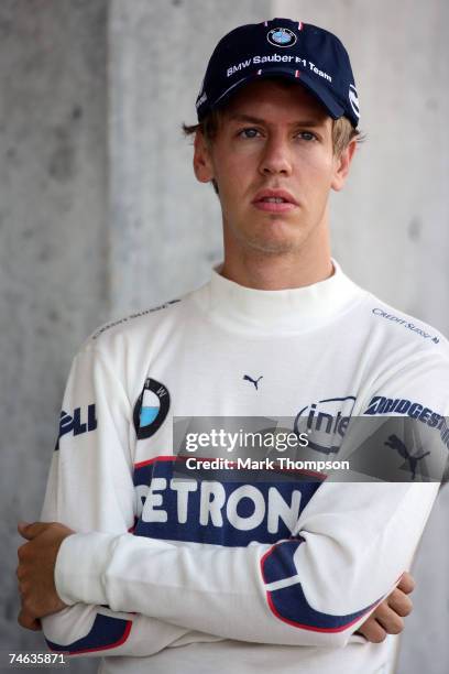 Sebastian Vettel of Germany and BMW Sauber looks on from the garage during practice for the F1 Grand Prix of USA at the Indianapolis Motor Speedway...