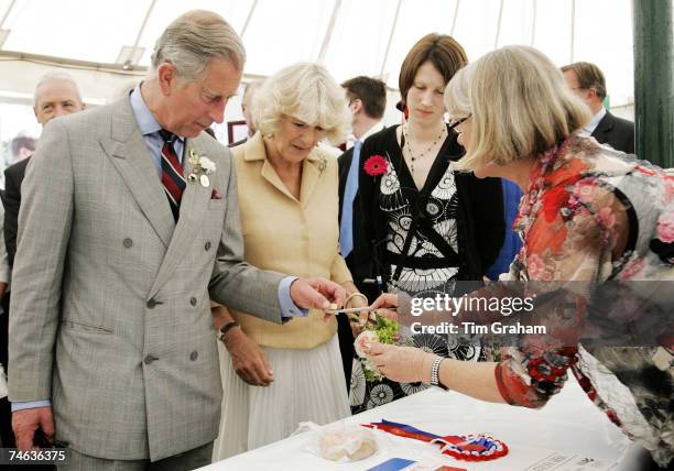 Prince Charles, Prince of Wales and Camilla, Duchess of Cornwall sample locally produced cheese during a visit to the Three Counties Show in its 50th...