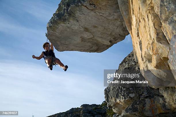 cliff hanger climbing a rock face - fish hoek stock pictures, royalty-free photos & images