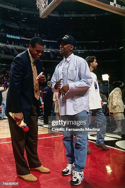 Sportscaster Ahmad Rashad has a laugh with actor Denzel Washington before a 1996 NBA game. NOTE TO USER: User expressly acknowledges that, by...